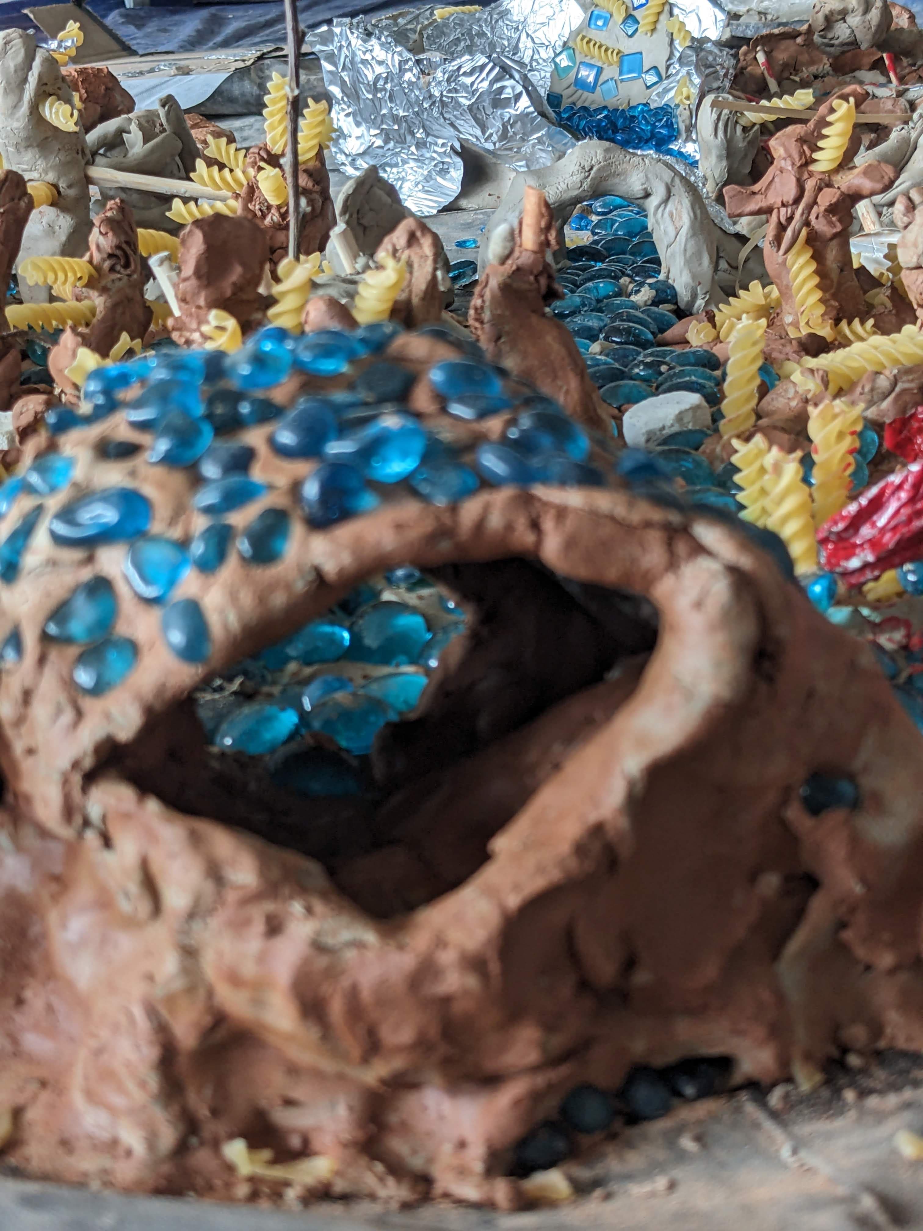 Art work from clay, blue marbles and pasta