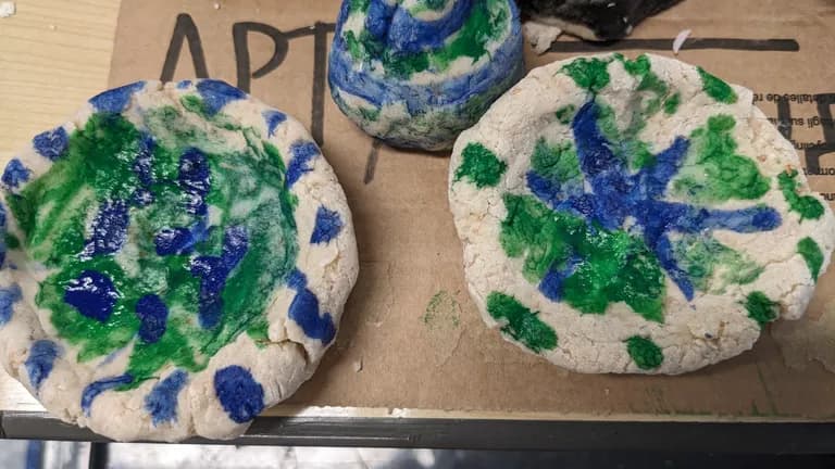Salt dough plates painted over in blue and green patterns